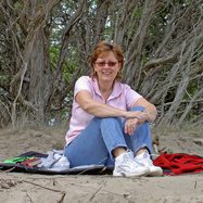 women sitting on the sand